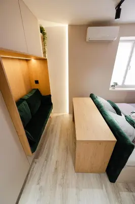 a small room with a bed and a couch at Studio Compact in Doboj