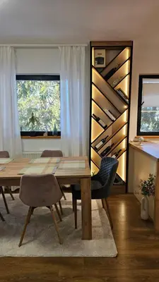 a dining room with a wooden table and chairs at Friends Vlašić in Vlasic