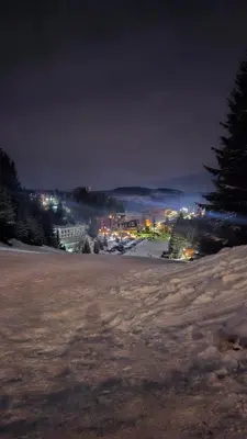 a field at night with a city in the background at Friends Vlašić in Vlasic