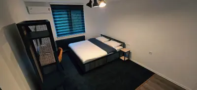 a small bedroom with a bed and a window at IB Oil doo Restoran s prenoćištem in Cazin