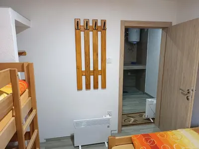 a room with a bedroom with a bed and a mirror at Apartmani Vila Alpe in Travnik