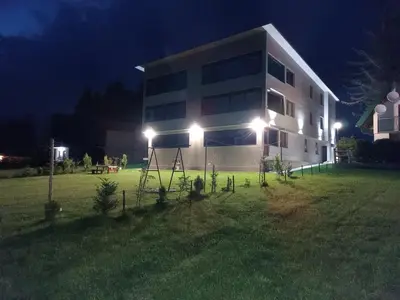 a large building with lights in front of it at night at Apartmani Vila Alpe in Travnik