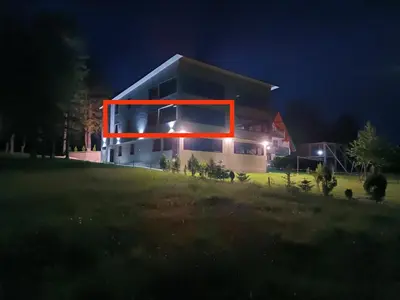 a house with a red frame on the side of it at Apartmani Vila Alpe in Travnik