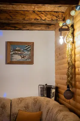 a living room with a couch and a christmas tree at Kuća za odmor Kupreška Čarolija in Kupres