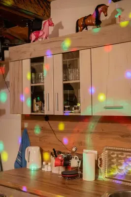 a kitchen counter with a cabinet with lights on it at Kuća za odmor Kupreška Čarolija in Kupres