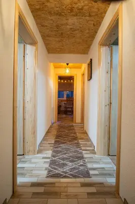 a hallway leading to a dining room with a table at Kuća za odmor Kupreška Čarolija in Kupres