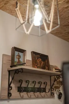 a shelf in a room with two pictures and a light at Kuća za odmor Kupreška Čarolija in Kupres
