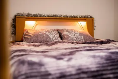 a bed with two pillows on top of it at Kuća za odmor Kupreška Čarolija in Kupres
