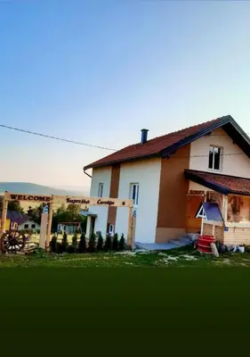 a house with a green yard in front of it at Kuća za odmor Kupreška Čarolija in Kupres