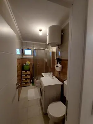 a small bathroom with a toilet and a sink at Vista Bihać in Bihać