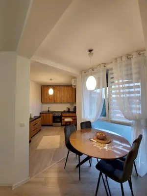a kitchen and dining room with a table and chairs at Vista Bihać in Bihać