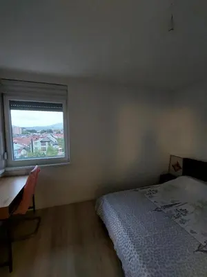 a bedroom with a bed and a window at Vista Bihać in Bihać
