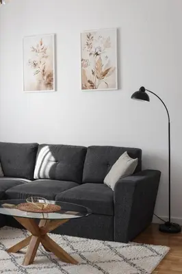 a living room with a gray couch and a table at City Central Apartment - Top location in Banja Luka