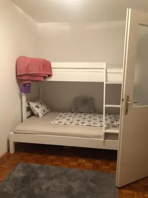 a white bunk bed in a room at Apartman Mokusnice Zenica in Zenica
