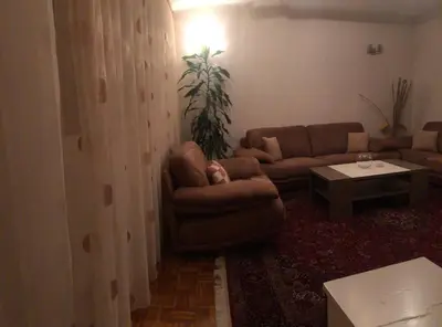 a living room with a couch and a table at Apartman Mokusnice Zenica in Zenica