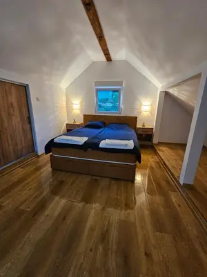 a large bedroom with a bed and a window at Skylight suite apartment in Tuzla