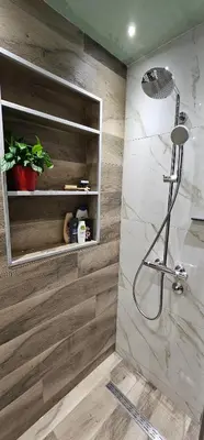 a bathroom with a shower with wooden walls at Skylight suite apartment in Tuzla