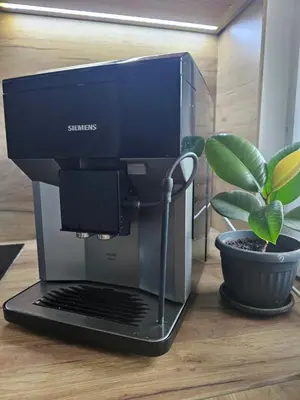 a laptop computer sitting on a table next to a plant at Skylight suite apartment in Tuzla