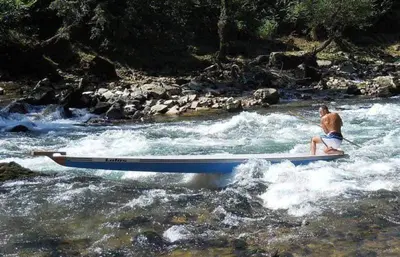 a man sitting on a boat in a river at Guest House Majstorovic in Banja Luka