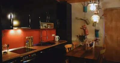 a kitchen with a sink and a counter with a table at Vila Nature in Zavidovići