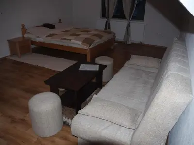 a living room with a couch and a bed at Motel Luka in Deževice