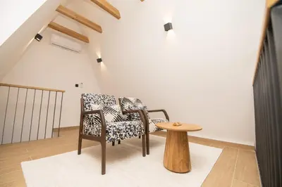 a living room with two chairs and a table at Vila Hill Rest in Visoko