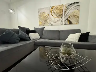 a living room with a couch and a glass table at Apartman Blanka in Banja Luka