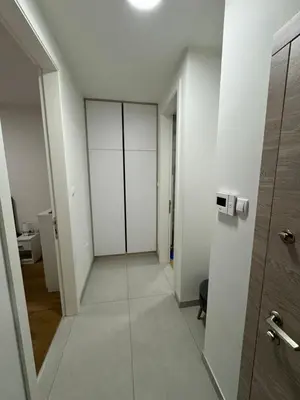 an empty hallway with white walls and a door at Apartman Blanka in Banja Luka