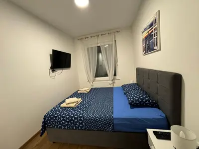 a bedroom with a bed and a television in it at Apartman Blanka in Banja Luka