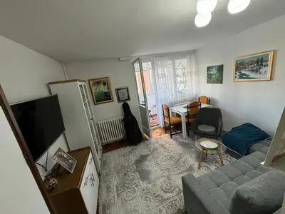 a living room with a couch and a table at Stan na dan in Zenica