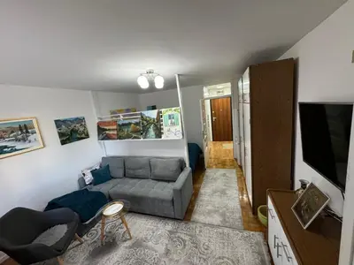 a living room with a couch and a tv at Stan na dan in Zenica