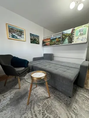 a living room with a couch and a table at Stan na dan in Zenica