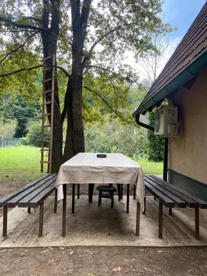 a picnic table and a bench in a park at Studio apartman Farah in Bihać