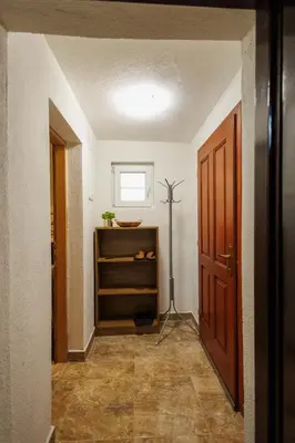a hallway with a room with a door and a shelf at Studio apartman Farah in Bihać
