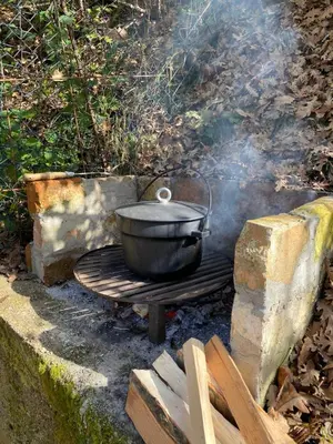 a pot on top of a grill on a fire at Studio apartman Farah in Bihać