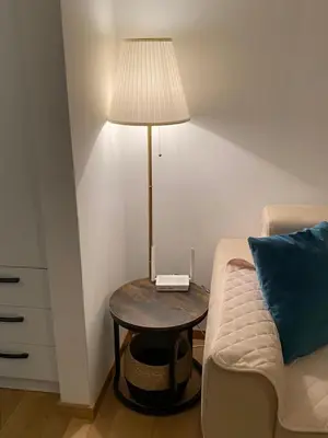 a table with a lamp on it next to a couch at RED home in Banja Luka