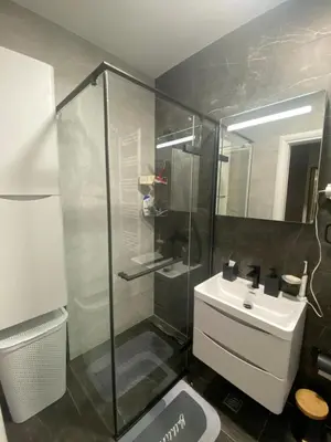 a bathroom with a glass shower and a sink at RED home in Banja Luka