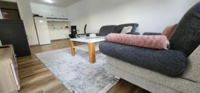 a living room with a couch and a table at Apartman Deny in Sanski most