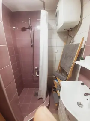 a bathroom with a shower with a toilet and a sink at Studio Apartman in Banja Luka