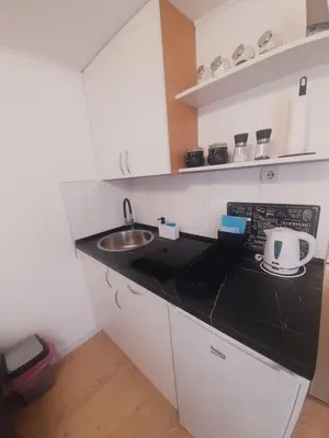a small kitchen with a sink and a counter top at Studio Apartman in Banja Luka
