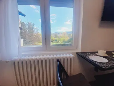 a room with a table and a window and a table and chair at Studio Apartman in Banja Luka