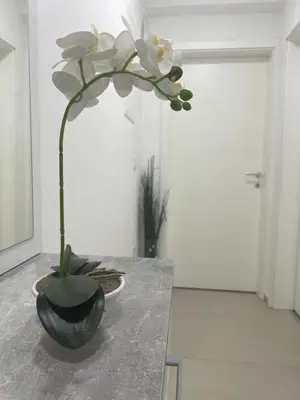 a vase with a flower on a table at Premium in Prijedor