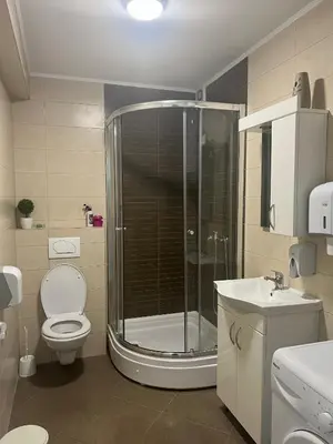 a bathroom with a shower and a toilet and a sink at Premium in Prijedor