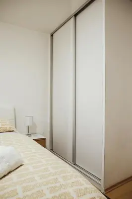 a bedroom with sliding glass doors at Ice Queen Vlasic in Šišava