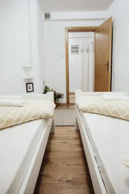 two beds in a room with a hallway at Ice Queen Vlasic in Šišava