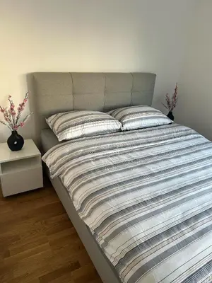 a large bed with two pillows on it in a bedroom at Apartmani Kastel 1 in Banja Luka