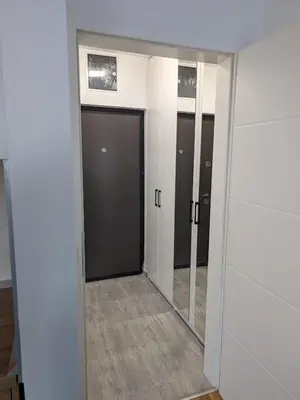 an empty hallway with two doors and a mirror at Apartmani Kastel 2 in Banja Luka