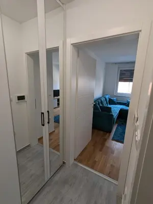 a living room with a sliding glass door at Apartmani Kastel 2 in Banja Luka