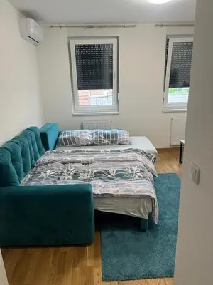 a living room with a bed and a couch at Apartmani Kastel 2 in Banja Luka