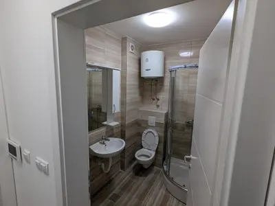 a bathroom with a toilet and a sink at Apartmani Kastel 2 in Banja Luka